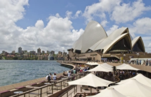 Closeup of restaurant umbrellas and famous Sydney Opera House in harbour in New South Closeup of restaurant umbrellas and famous Sydney Opera House in harbour in New South