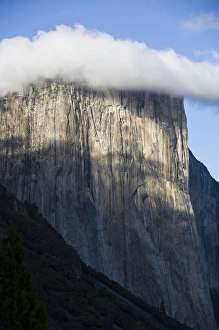 A cloud forms atop El Capitan shrouding the top of the cliff-face - Yosemite National Park A cloud forms atop El Capitan shrouding the top of the cliff-face - Yosemite National Park