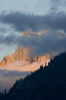 Clouds circle Half Dome at sunset - Yosemite National Park, California Clouds circle Half Dome at sunset - Yosemite National Park, California