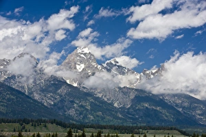 Clouds move over Grand Teton peak on a sunny day - Grand Teton National Park, Wyoming Clouds move over Grand Teton peak on a sunny day - Grand Teton National Park, Wyoming