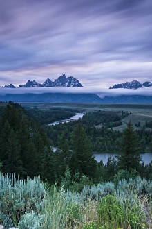 Clouds illuminate with red light above the Grand Teton mountains seen from the Snake Clouds illuminate with red light above the Grand Teton mountains seen from the Snake
