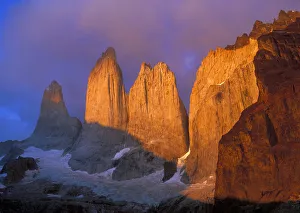Clouds swirl around the sunrise-colored rocky points of Cerro del Torres in Patagonia Clouds swirl around the sunrise-colored rocky points of Cerro del Torres in Patagonia