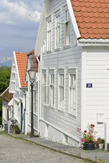 Coble stone Streets and white timber houses of the Stavanger Historical district Coble stone Streets and white timber houses of the Stavanger Historical district