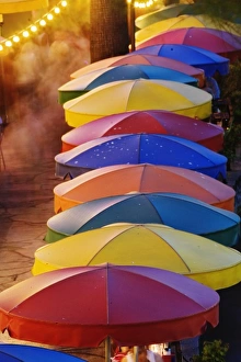 Colorful umbrellas of outdoor cafe and blurred people in motion along famous River Walk Colorful umbrellas of outdoor cafe and blurred people in motion along famous River Walk