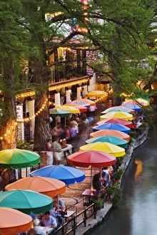 Colorful umbrellas of outdoor cafe along famous River Walk, and San Antonio River Colorful umbrellas of outdoor cafe along famous River Walk, and San Antonio River
