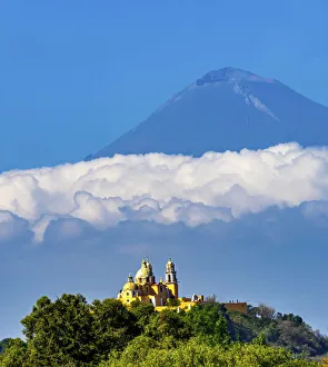 Colorful yellow Iglesia de Nuestra Senora de los Remedios, Popocatepetl, Cholula, Puebla Colorful yellow Iglesia de Nuestra Senora de los Remedios, Popocatepetl, Cholula, Puebla
