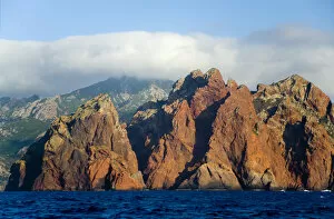 Images Dated 18th June 2008: Corsica. France. Europe. Pinnacles of red granite at rise out of the sea at Punta Muchillina