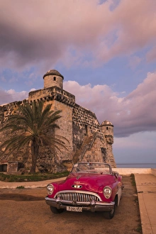 Cuba, Cojimar. Classic American car parked in front of a fort Cuba, Cojimar. Classic American car parked in front of a fort