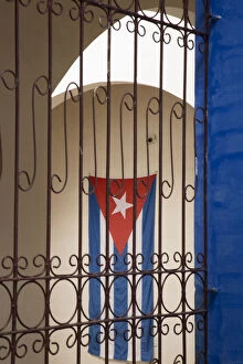 Still Life Collection: Cuba, Vinales, Cuban flag in courtyard and wrought iron gate
