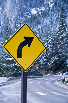 A curve ahead road sign warns visitors entering Yosemite valley on California State A curve ahead road sign warns visitors entering Yosemite valley on California State