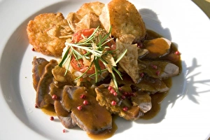 A dish of pork tenderloin and potato at a restaurant near Le Mont Saint Michel in A dish of pork tenderloin and potato at a restaurant near Le Mont Saint Michel in