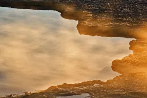 Edge of hotspring near sunset, Midway Geyser Basin, Yellowstone National Park, Wyoming Edge of hotspring near sunset, Midway Geyser Basin, Yellowstone National Park, Wyoming