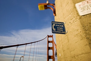 Emergency Phone and Crisis Counseling sign on the Golden Gate Bridge - San Francisco Emergency Phone and Crisis Counseling sign on the Golden Gate Bridge - San Francisco