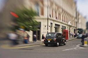 England, London. Black taxicab zooms through Londons streets England, London. Black taxicab zooms through Londons streets
