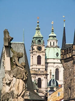 Images Dated 25th April 2014: Europe, Czech Republic, Prague. Statue on the Charles bridge and the St. Nicholas church