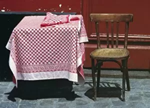 Europe, France, Paris. A sidewalk table for one welcomes a diner in the Montmartre