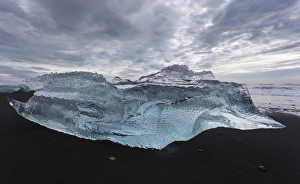 Europe, Iceland. Iceberg piece from Jokulsarlon Lagoon washed onto black sand beach by storm Europe, Iceland. Iceberg piece from Jokulsarlon Lagoon washed onto black sand beach by storm