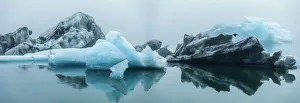 Europe, Iceland. Morning fog softens the light shining on icebergs floating in Europe, Iceland. Morning fog softens the light shining on icebergs floating in