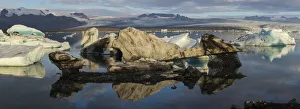 Europe, Iceland. Morning light shines on a panoramic view of icebergs floating in Europe, Iceland. Morning light shines on a panoramic view of icebergs floating in