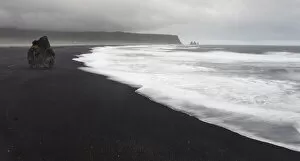 Images Dated 22nd July 2012: Europe, Iceland, Vik. Basalt column rises from black sand beach on rainy day. Credit as