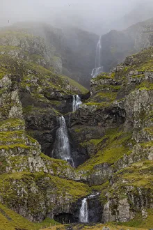 Europe, Iceland. Thin waterfall cascades down a mountainside in southern Iceland Europe, Iceland. Thin waterfall cascades down a mountainside in southern Iceland