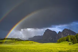 Europe, Italy, Dolomites, Alpe di Siusi. Double rainbow over mountain meadow. Credit as Europe, Italy, Dolomites, Alpe di Siusi. Double rainbow over mountain meadow. Credit as
