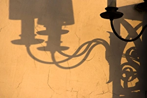 Europe, Italy, Venice. Lamp and shadows on a yellow wall Europe, Italy, Venice. Lamp and shadows on a yellow wall