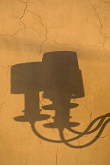 Europe, Italy, Venice. Shadows of a lamp on a yellow wall Europe, Italy, Venice. Shadows of a lamp on a yellow wall