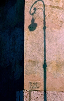 Europe, Italy, Verona. Shadow of street lamp on wall Europe, Italy, Verona. Shadow of street lamp on wall