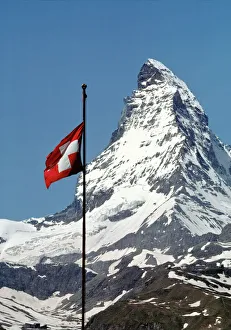 Europe, Switzerland, Matterhorn. The Swiss flag flies proudly at the base of the Europe, Switzerland, Matterhorn. The Swiss flag flies proudly at the base of the