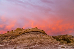 Fiery sunrise clouds over badlands at dawn in Theodore Roosevelt National Park, North Dakota Fiery sunrise clouds over badlands at dawn in Theodore Roosevelt National Park, North Dakota
