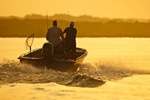 Images Dated 5th June 2010: Fishermen boating toward the Laguna Madre, Texas, sunrise