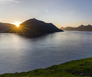 Fjord Fuglafjordur and Leirviksfjordur at sunset, in the background the mountains Fjord Fuglafjordur and Leirviksfjordur at sunset, in the background the mountains