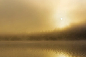 Foggy sunrise over Beaver Lake in the Stillwater State Forest near Whitefish, Montana Foggy sunrise over Beaver Lake in the Stillwater State Forest near Whitefish, Montana
