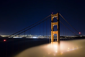 A foggy view of the Golden Gate Bridge and San Francisco with a clear sky above A foggy view of the Golden Gate Bridge and San Francisco with a clear sky above
