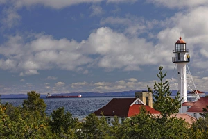 Freighter bound for Canada passing Whitefish Point Lighthouse, the oldest operating Freighter bound for Canada passing Whitefish Point Lighthouse, the oldest operating