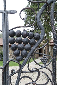 Georgia, Mtskheta. Decorative grapes on a metal fence Georgia, Mtskheta. Decorative grapes on a metal fence