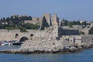 Greece, Rhodes. Aegean Sea harbor view of the walled medieval Old Town. UNESCO Greece, Rhodes. Aegean Sea harbor view of the walled medieval Old Town. UNESCO