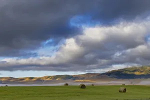 Hay bales in clearing fog with Salish Mountains in Lake County, Montana, USA Hay bales in clearing fog with Salish Mountains in Lake County, Montana, USA