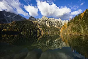 The high mountains of the Rieserferner Alps are reflecting in the Antholzer See (lake antholz)