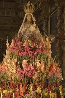 Images Dated 16th May 2005: Huge display of flowers and candles under statue of Virgin Purificada, Church of Santa Clara