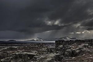 Iceland, Fagrabrekka, Thingvellir National Park. Storm clouds above an otherworldly landscape Iceland, Fagrabrekka, Thingvellir National Park. Storm clouds above an otherworldly landscape