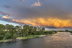 Incredible stormy light on the Madison River at sunset near Ennis, Montana, USA Incredible stormy light on the Madison River at sunset near Ennis, Montana, USA