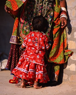 India, Gujurat. Shy child hugs Megwar Tribe woman mother India, Gujurat. Shy child hugs Megwar Tribe woman mother