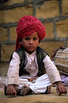 Images Dated 8th June 2007: India, Rajasthan, Jaisalmer. Boy dancer rests between songs at entrance to Jaisalmer Fort