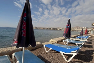 Israel, Eilat, beach lounge chairs and umbrellas along the sea at this popular resort Israel, Eilat, beach lounge chairs and umbrellas along the sea at this popular resort
