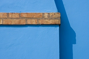 Italy, Burano. Close-up of blue stucco exterior of chimney and colored brick Italy, Burano. Close-up of blue stucco exterior of chimney and colored brick