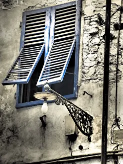 Italy, Pisa. Double windows and lamp on old building Italy, Pisa. Double windows and lamp on old building