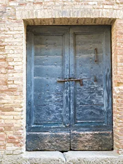 Italy, Tuscany. Old blue door with iron latch in a village in Tuscany Italy, Tuscany. Old blue door with iron latch in a village in Tuscany
