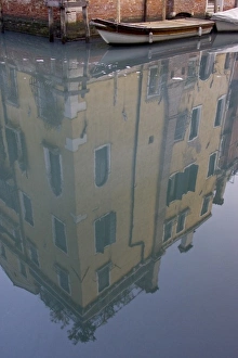 Italy, Venice. Building and boat reflected in still canal Italy, Venice. Building and boat reflected in still canal